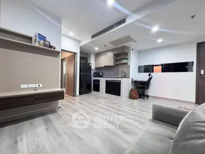 Modern open-layout living room with sleek kitchen and stylish decor