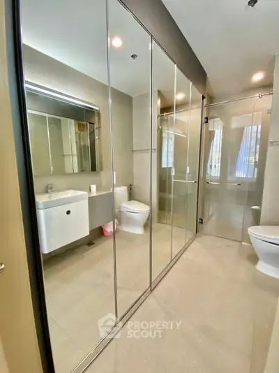Modern bathroom with mirrored cabinets and sleek fixtures