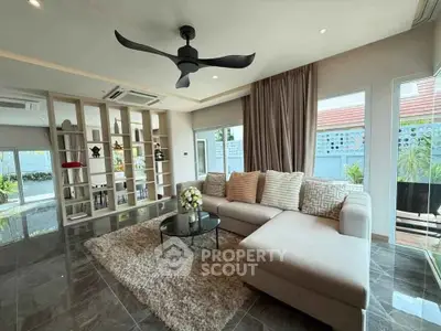 Spacious living room with modern decor and large windows for natural light.