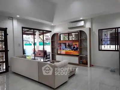 Spacious living room with modern decor and large windows for natural light