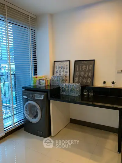 Modern laundry area with washing machine and stylish decor in a bright apartment