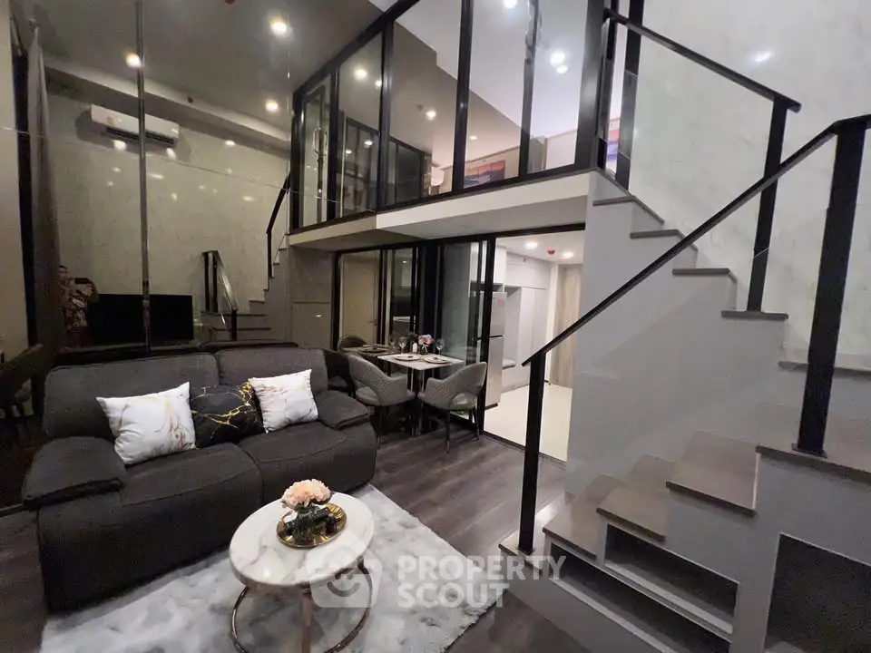 Modern duplex living room with stylish decor and open staircase