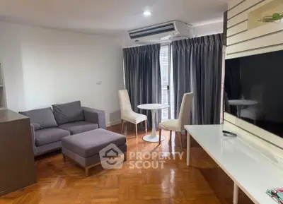 Modern living room with sleek furniture and natural light, featuring a cozy sofa and elegant dining area.