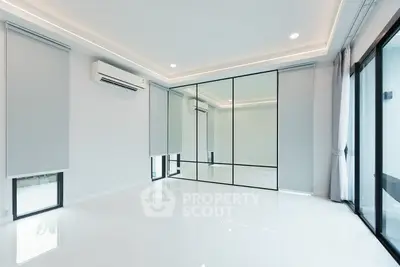 Spacious modern living room with large mirrors and sleek design