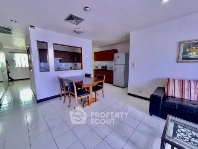 Spacious open-plan living and dining area with modern kitchen in a stylish apartment.
