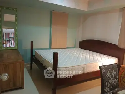 Cozy bedroom with wooden furniture and comfortable mattress