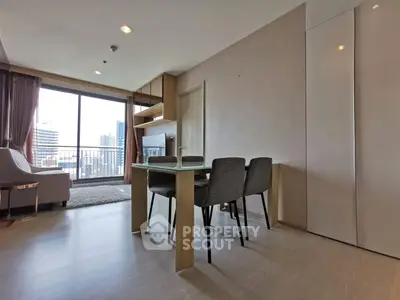 Modern living room with dining area and city view balcony in high-rise apartment.