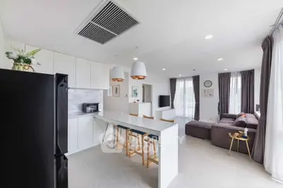 Spacious modern living room with open kitchen and stylish decor