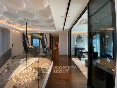 Luxurious modern interior with elegant chandelier and stylish decor in a spacious living area.