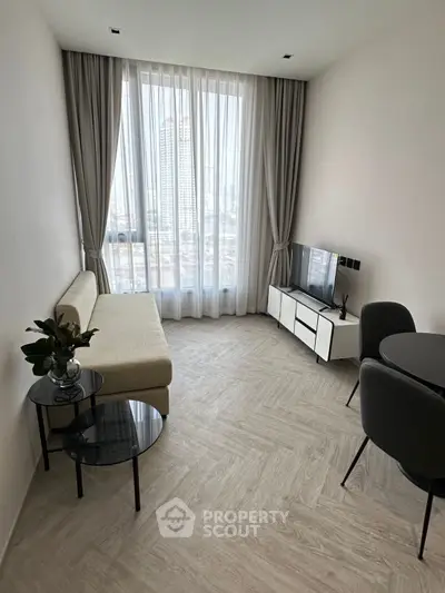 Modern living room with city view, featuring sleek furniture and elegant decor.