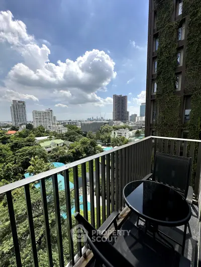 Stunning balcony view with lush greenery and city skyline, perfect for relaxation.