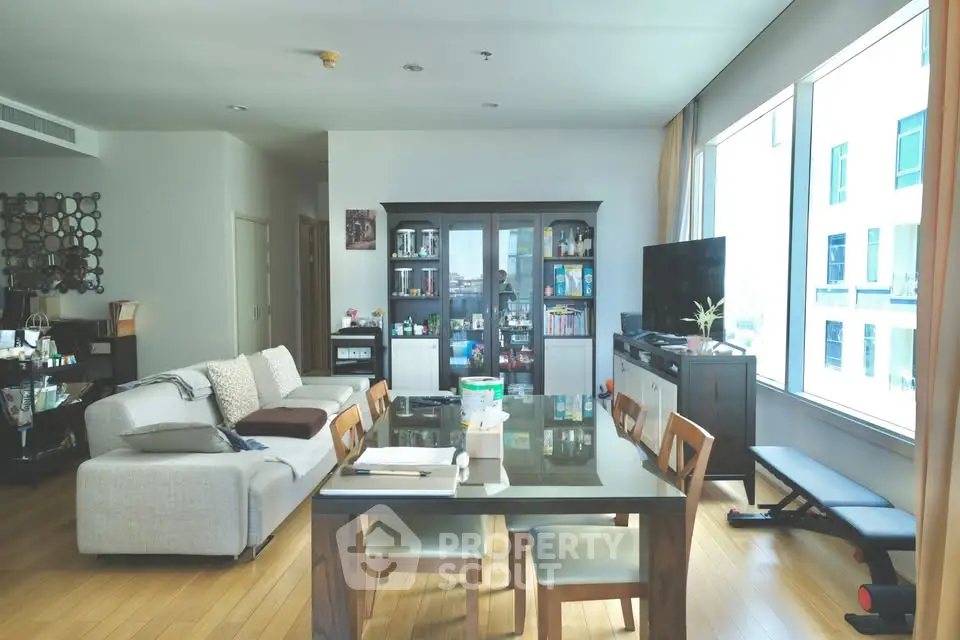 Spacious living room with modern furniture and large windows offering natural light.