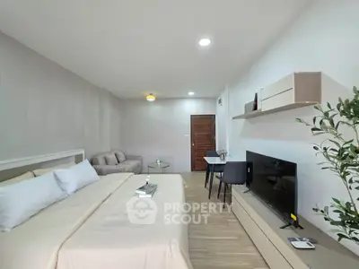 Modern studio apartment with cozy living area and stylish decor