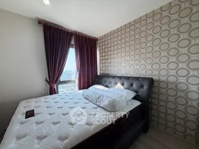 Cozy bedroom with stylish wallpaper and large window offering city views