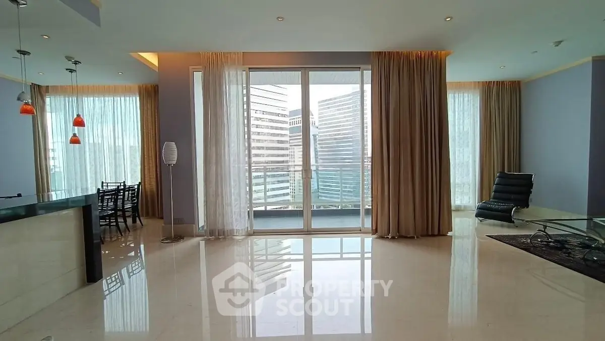 Spacious modern living room with floor-to-ceiling windows and city view