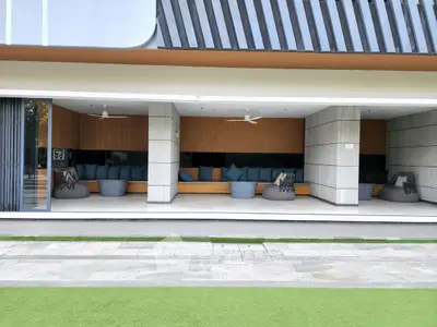 Modern outdoor seating area with stylish design and comfortable furnishings in a luxury building.