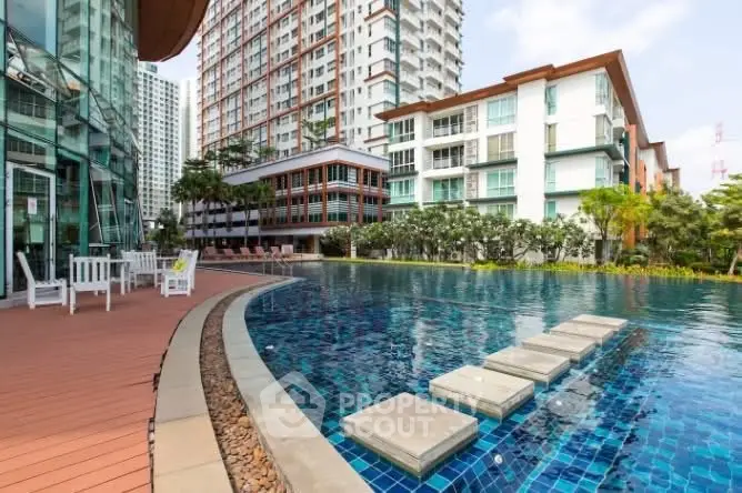 Luxurious apartment complex with stunning pool and modern architecture.