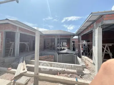 Modern construction site showcasing a new residential building under clear blue skies.