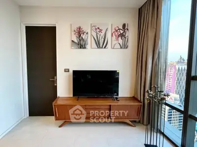 Modern living room with stylish TV stand and city view through large windows.