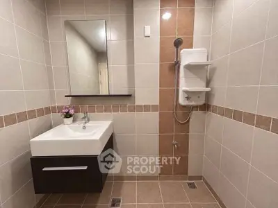 Modern bathroom with sleek vanity and shower in stylish tile design.
