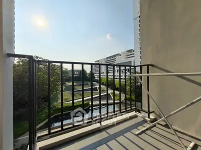 Modern balcony with scenic view of urban landscape and greenery, perfect for relaxation and enjoying sunsets.