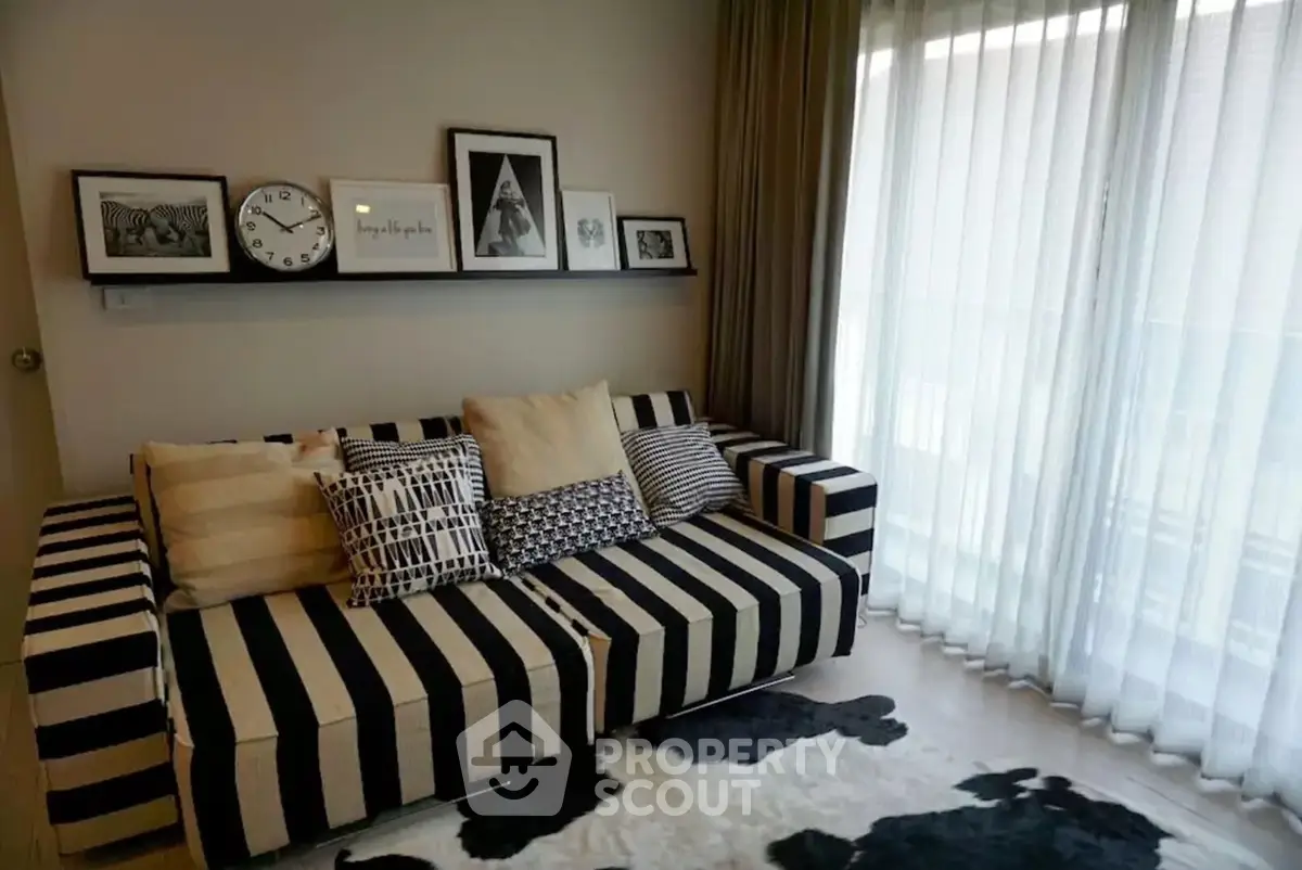 Stylish living room with striped sofa and modern decor, perfect for cozy relaxation.
