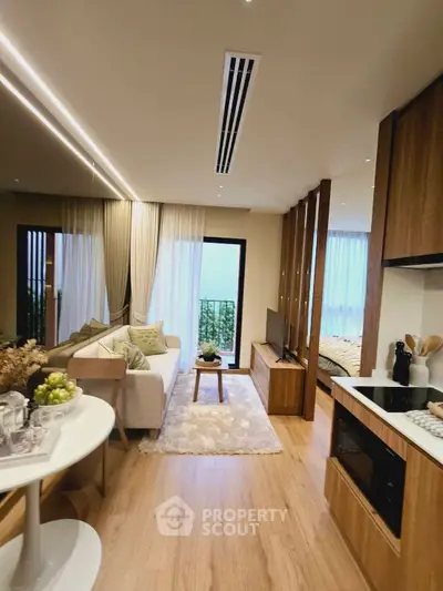 Modern open-plan living room with cozy seating and stylish kitchen area.