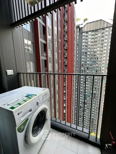 Modern high-rise apartment balcony with washing machine and city view
