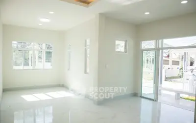 Spacious and bright living room with large windows and sliding glass doors.