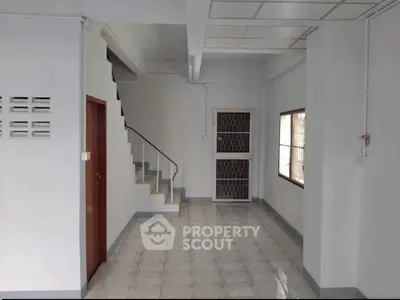 Spacious interior with staircase and tiled flooring, ideal for modern living.