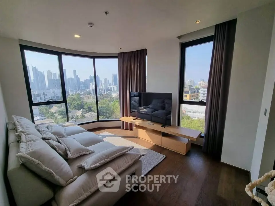 Luxurious living room with panoramic city views and modern furnishings.