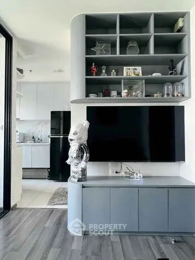 Modern living room with sleek TV unit and open kitchen design