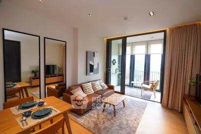 Modern living room with stylish decor and balcony view in a luxury apartment.