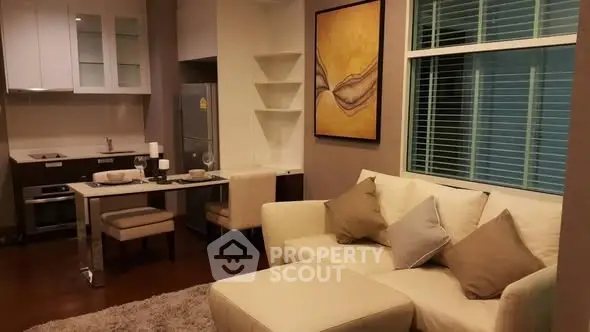 Modern living room with cozy sofa and stylish kitchen area