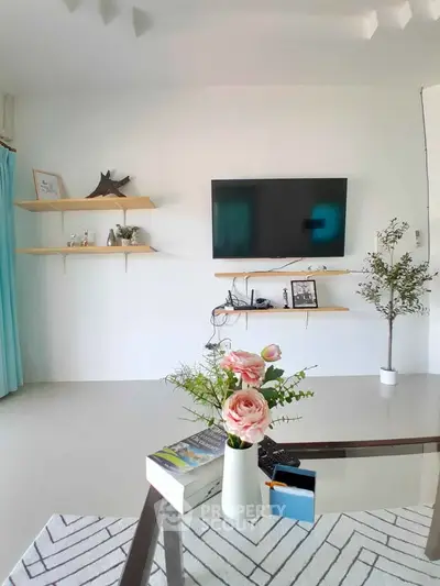 Modern living room with wall-mounted TV and minimalist decor