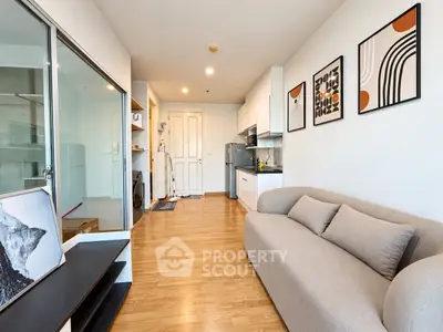 Modern living room with stylish decor and open kitchen layout in a contemporary apartment.