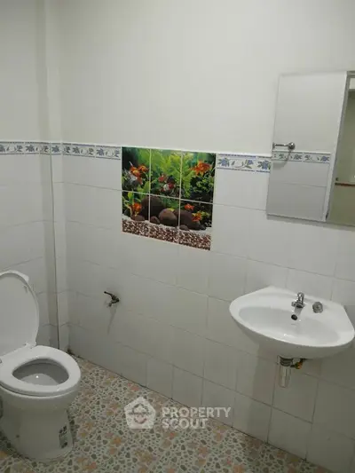 Simple bathroom with white tiles and decorative wall art