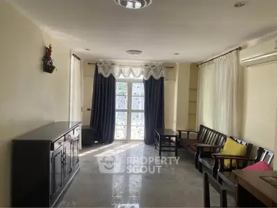 Spacious living room with elegant furniture and large windows for natural light.