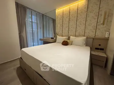 Modern bedroom with elegant decor and large window for natural light