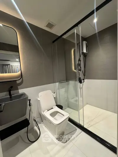 Modern bathroom with sleek fixtures and glass shower enclosure