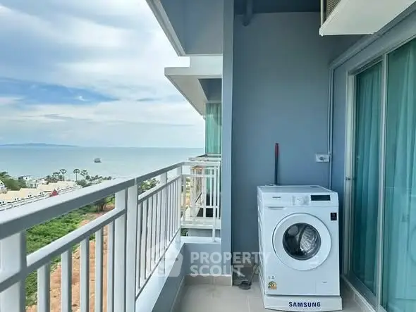 Stunning balcony with ocean view and modern washing machine setup.