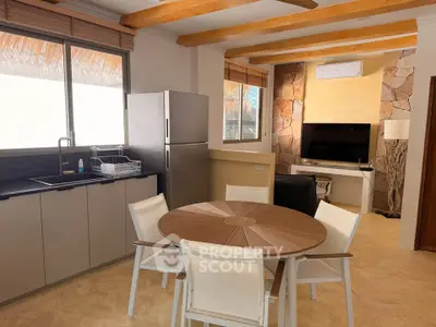 Modern kitchen and living area with stylish furniture and natural light