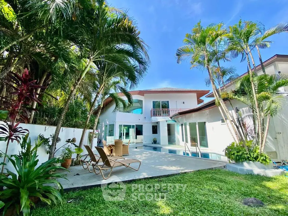 Luxurious tropical villa with pool and lush garden, perfect for relaxation and entertaining.