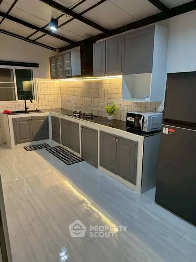 Modern kitchen with sleek cabinetry and gas stove in stylish home