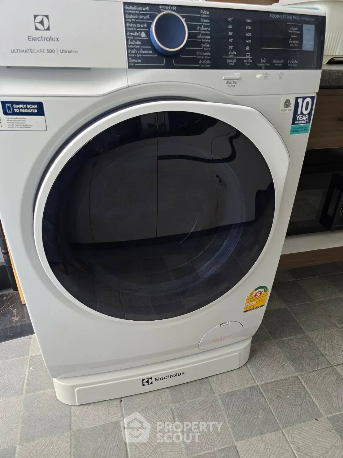 Modern Electrolux washing machine in sleek laundry room setting.