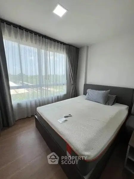 Modern bedroom with large window and stylish decor