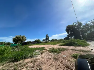 Spacious vacant land with clear blue sky, ideal for development opportunities.