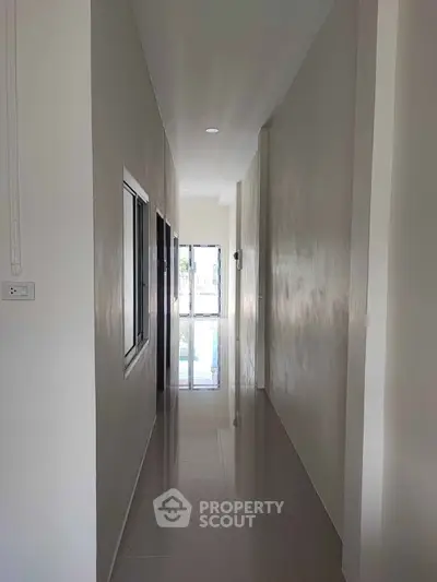 Sleek modern hallway with glossy floors and natural light