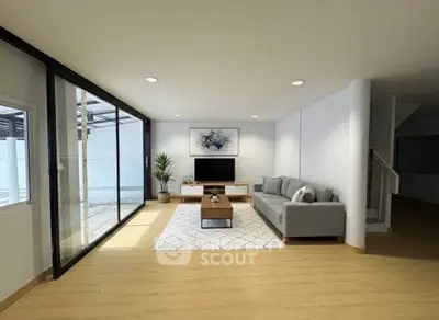 Spacious modern living room with large windows and stylish decor