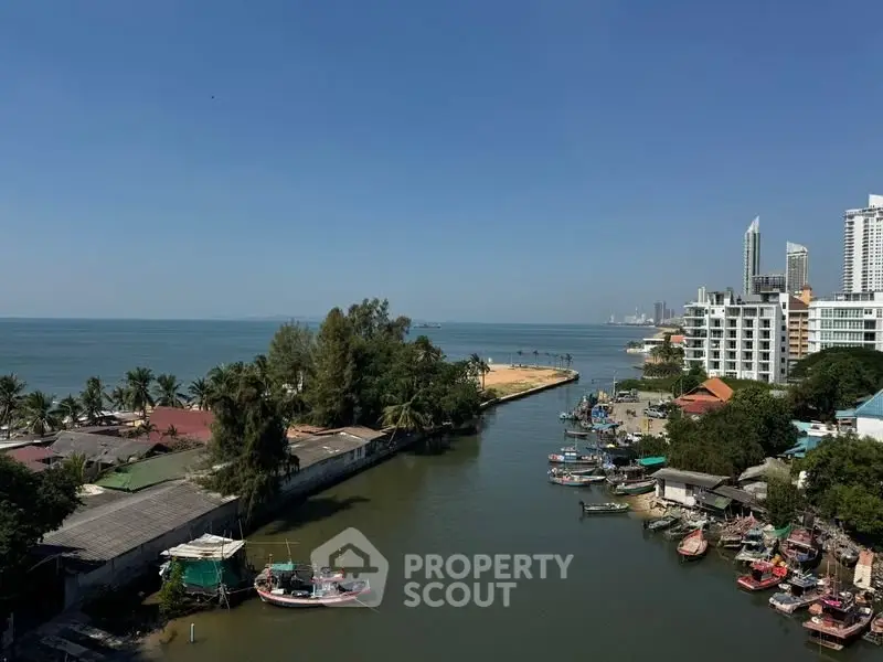 Stunning coastal view with modern buildings and serene waterfront, perfect for luxury living.